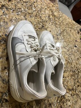 White Nike Air Sneakers with Silver Accent